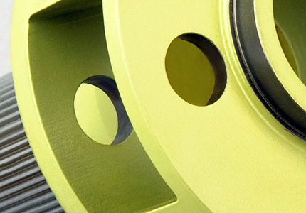 a close-up of a mechanical part with a vibrant yellow coating, possibly for corrosion resistance or as part of a branding color scheme. The piece exhibits a combination of circular holes and precision-machined flat surfaces with rounded corners, suggesting it's part of a larger assembly, possibly a gearbox or machinery. The surface finish is smooth, which indicates high-quality machining standards. This part could be used in various industrial applications, requiring durability and strength.